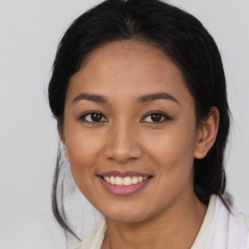 Joyful latino young-adult female with medium  black hair and brown eyes