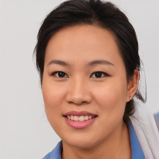 Joyful asian young-adult female with medium  brown hair and brown eyes
