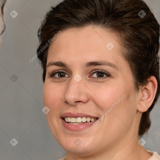 Joyful white young-adult female with medium  brown hair and brown eyes