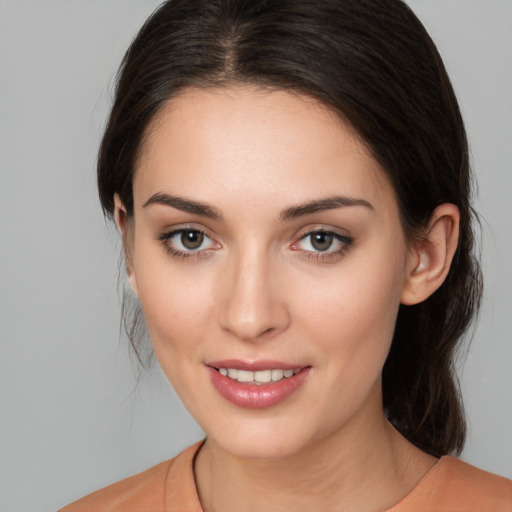 Joyful white young-adult female with medium  brown hair and brown eyes