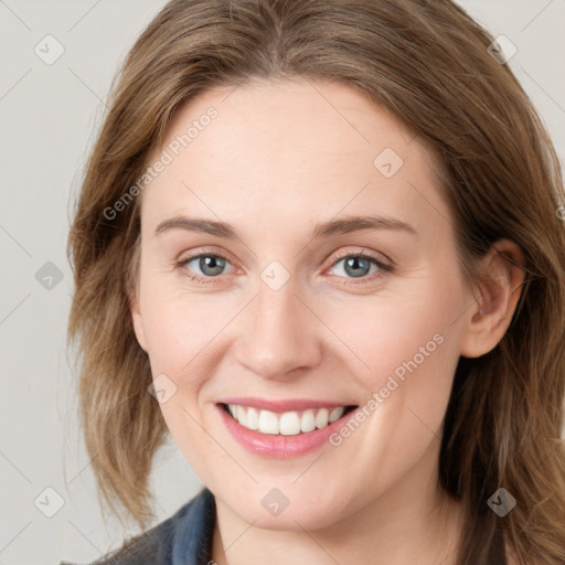 Joyful white young-adult female with long  brown hair and blue eyes