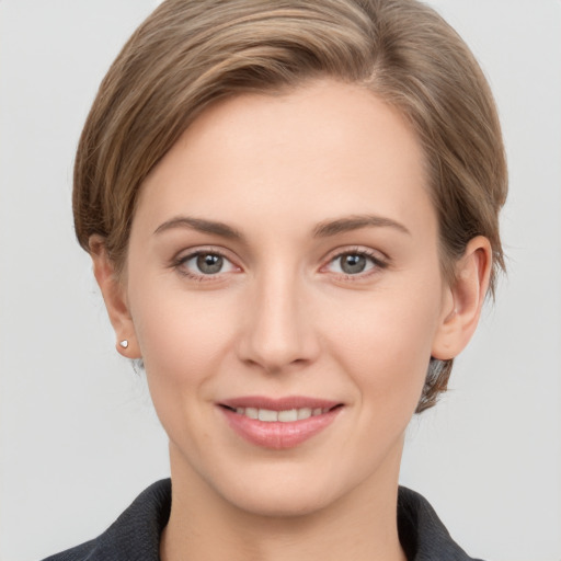 Joyful white young-adult female with short  brown hair and grey eyes