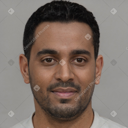 Joyful black young-adult male with short  black hair and brown eyes