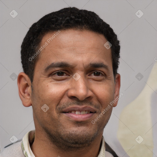 Joyful latino adult male with short  black hair and brown eyes