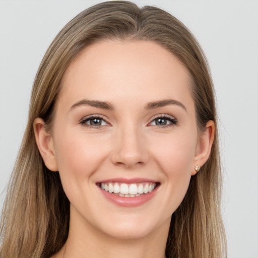 Joyful white young-adult female with long  brown hair and grey eyes