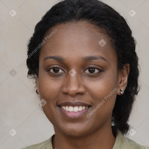 Joyful black young-adult female with long  brown hair and brown eyes