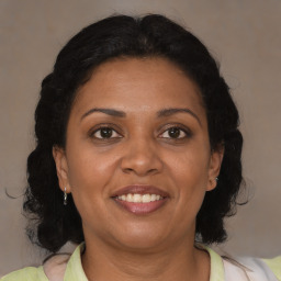 Joyful black adult female with medium  brown hair and brown eyes