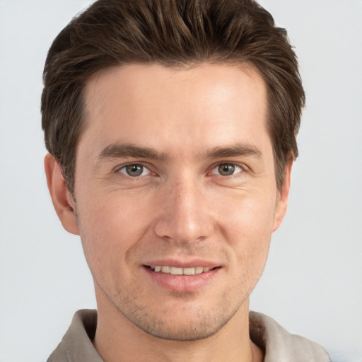 Joyful white adult male with short  brown hair and grey eyes