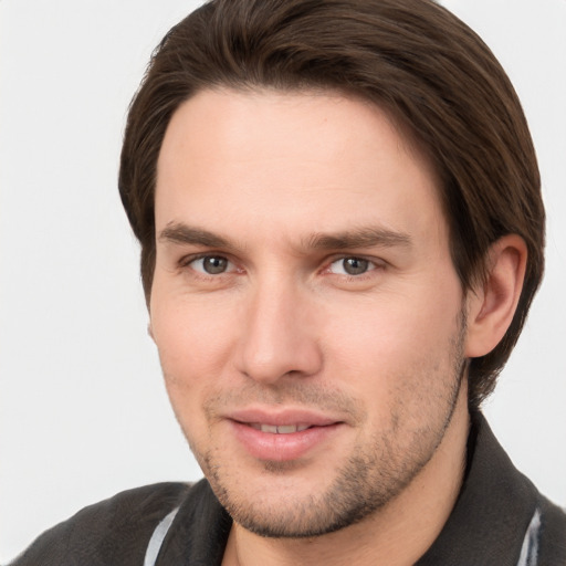 Joyful white young-adult male with short  brown hair and grey eyes