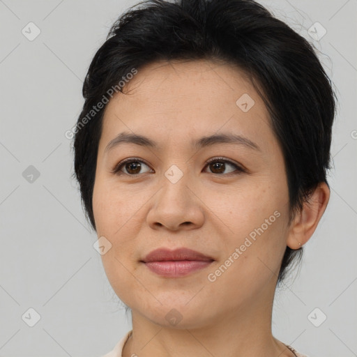 Joyful asian adult female with medium  brown hair and brown eyes