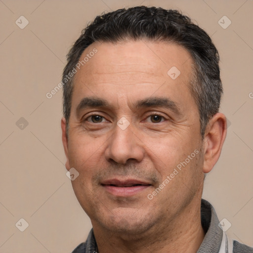 Joyful white adult male with short  black hair and brown eyes