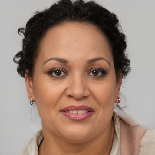 Joyful latino adult female with short  brown hair and brown eyes