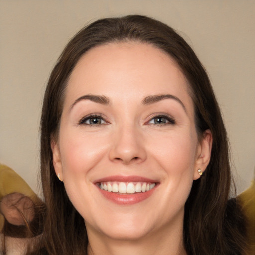 Joyful white young-adult female with long  brown hair and brown eyes