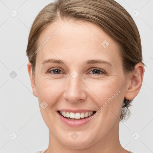 Joyful white young-adult female with short  brown hair and grey eyes