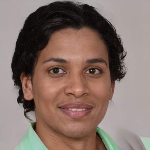 Joyful latino adult female with short  brown hair and brown eyes