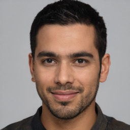 Joyful white young-adult male with short  black hair and brown eyes