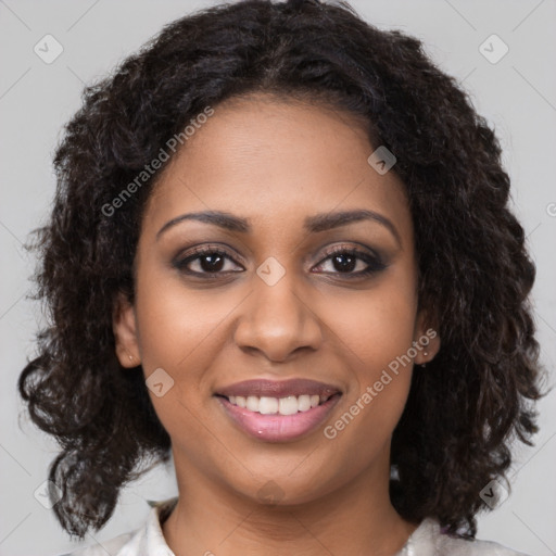 Joyful black young-adult female with long  brown hair and brown eyes