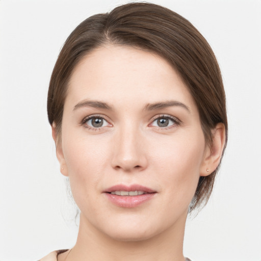 Joyful white young-adult female with medium  brown hair and grey eyes