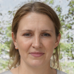 Joyful white adult female with medium  brown hair and brown eyes