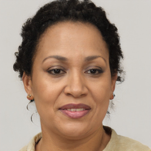 Joyful black adult female with short  brown hair and brown eyes