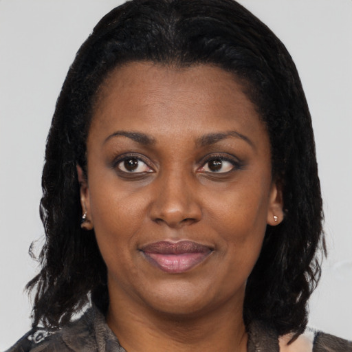 Joyful black young-adult female with medium  black hair and brown eyes