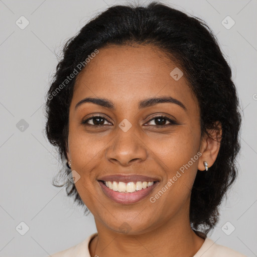 Joyful black young-adult female with long  brown hair and brown eyes