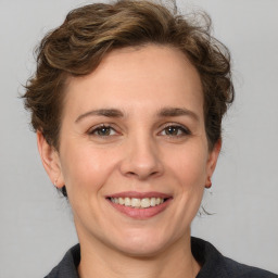 Joyful white adult female with medium  brown hair and grey eyes