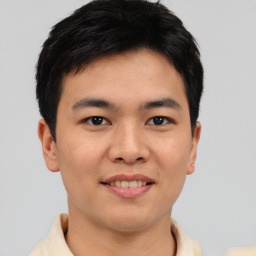 Joyful asian young-adult male with short  black hair and brown eyes