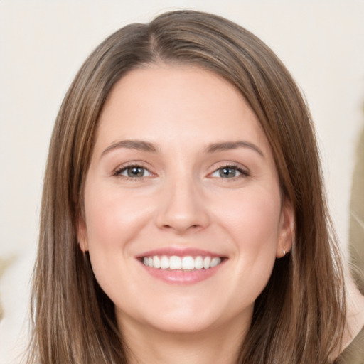 Joyful white young-adult female with long  brown hair and brown eyes