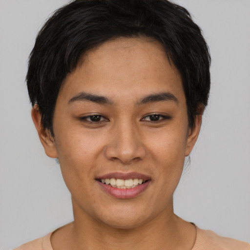 Joyful asian young-adult female with short  black hair and brown eyes