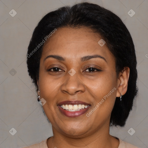 Joyful latino adult female with medium  brown hair and brown eyes