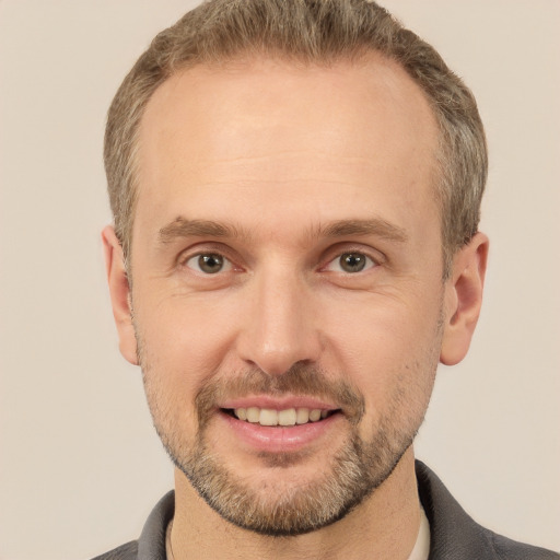 Joyful white adult male with short  brown hair and brown eyes