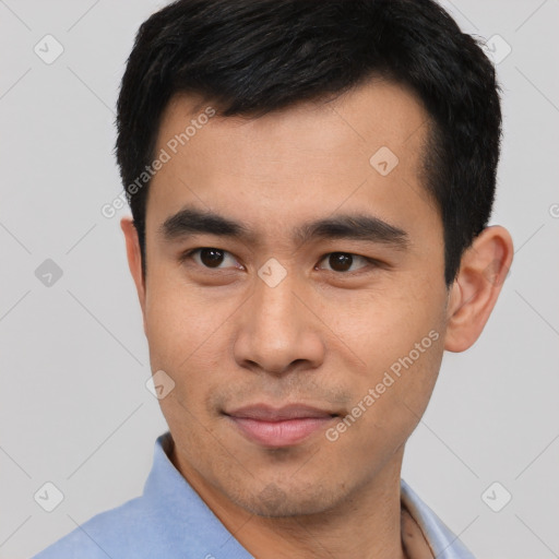 Joyful asian young-adult male with short  black hair and brown eyes