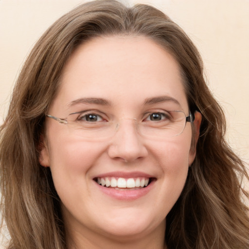 Joyful white young-adult female with long  brown hair and green eyes