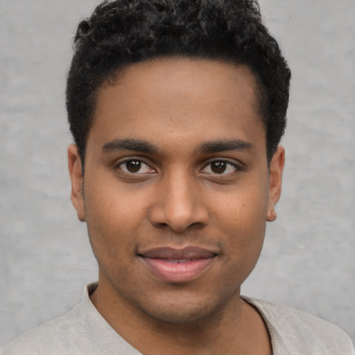 Joyful latino young-adult male with short  brown hair and brown eyes