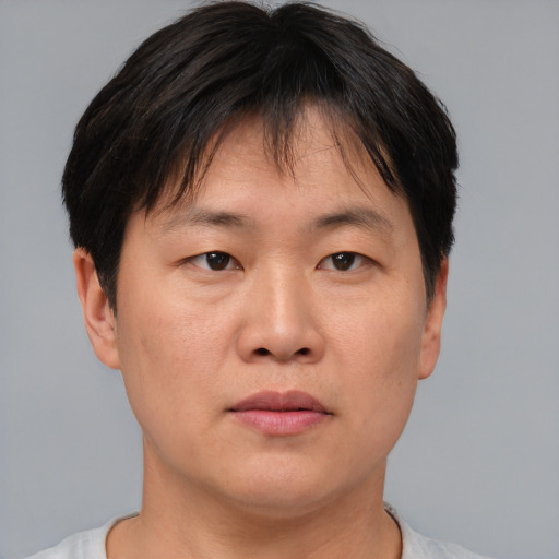 Neutral asian adult male with short  brown hair and brown eyes
