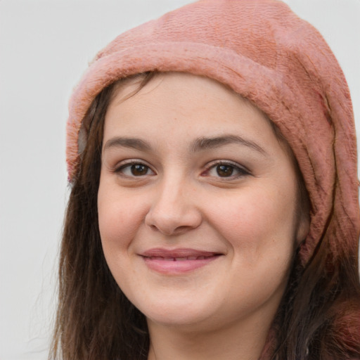 Joyful white young-adult female with long  brown hair and brown eyes