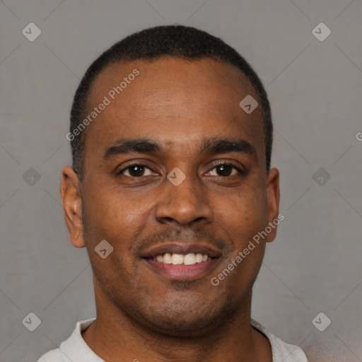 Joyful black young-adult male with short  brown hair and brown eyes