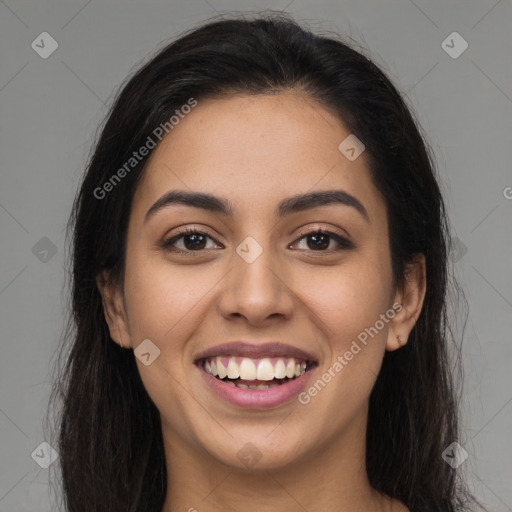 Joyful latino young-adult female with long  brown hair and brown eyes