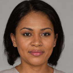 Joyful black adult female with medium  brown hair and brown eyes