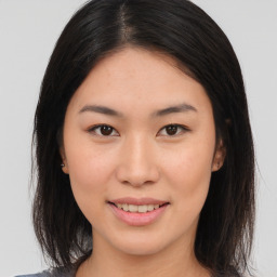 Joyful asian young-adult female with medium  brown hair and brown eyes