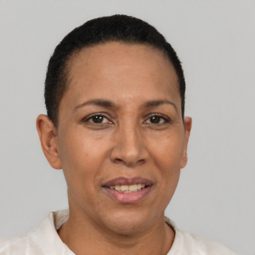 Joyful latino adult female with short  brown hair and brown eyes