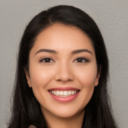 Joyful latino young-adult female with long  brown hair and brown eyes