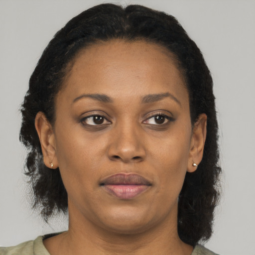 Joyful black adult female with short  brown hair and brown eyes
