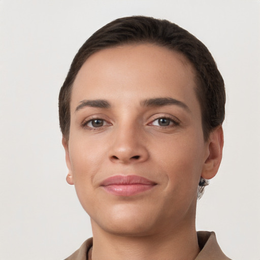 Joyful white young-adult female with short  brown hair and brown eyes