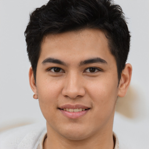 Joyful asian young-adult male with short  brown hair and brown eyes