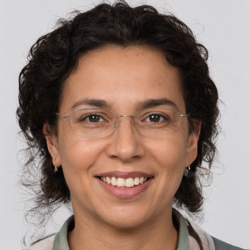 Joyful white adult female with medium  brown hair and brown eyes