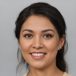 Joyful latino young-adult female with medium  brown hair and brown eyes