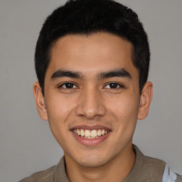 Joyful latino young-adult male with short  brown hair and brown eyes