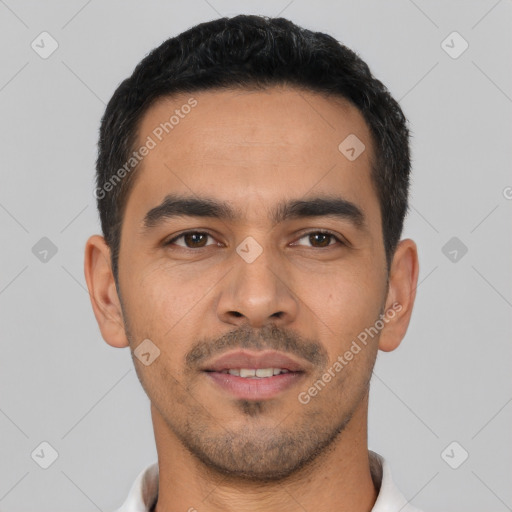 Joyful latino young-adult male with short  black hair and brown eyes